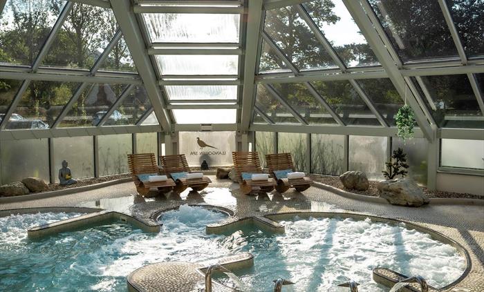 Spa wellness pool at Wild Pheasant Hotel & Spa with bubbling water, illuminated by natural daylight, creating a relaxing and rejuvenating atmosphere.